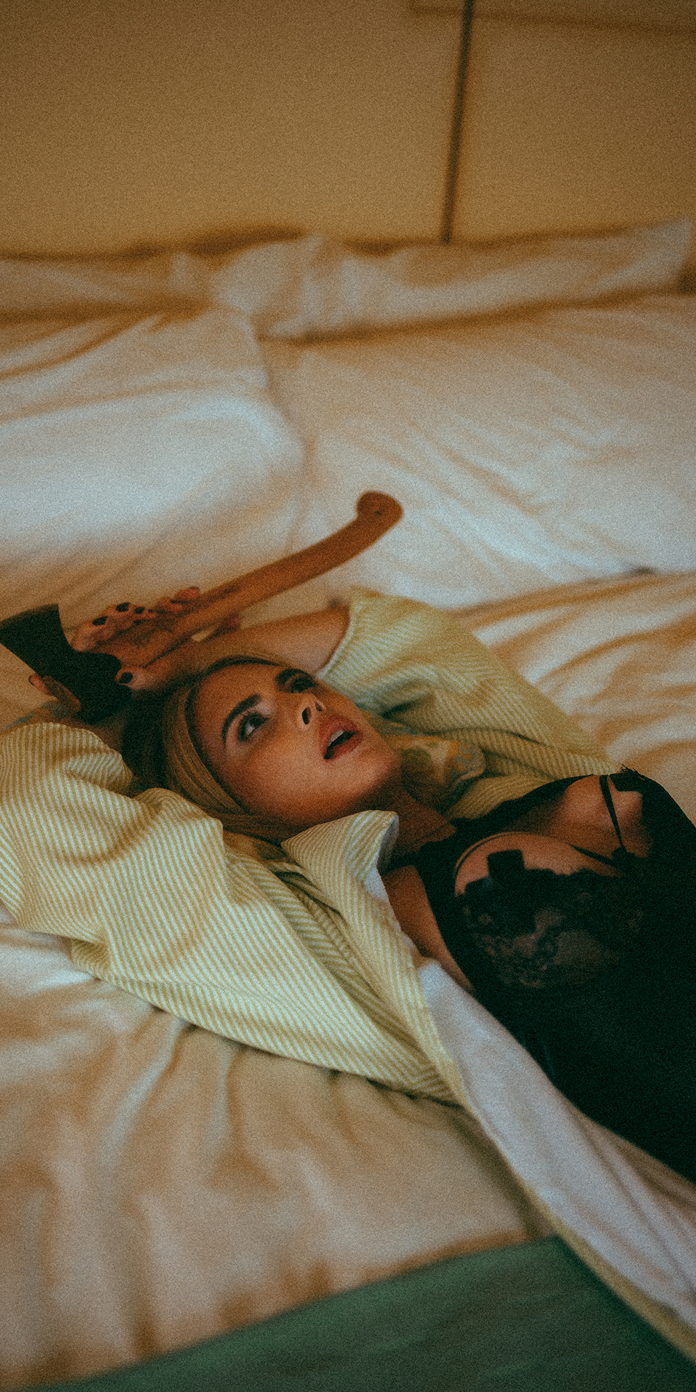 lucy hart holding a hatchet in bed